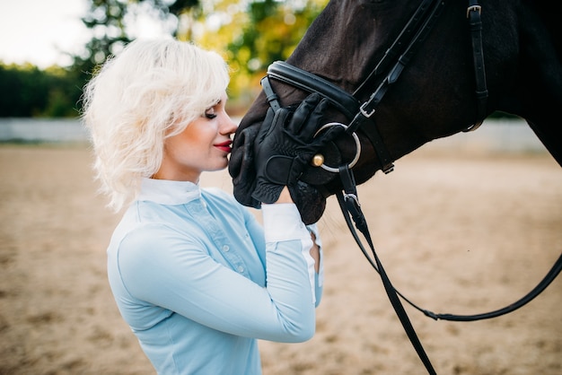 Femme embrasse son cheval, amitié, équitation