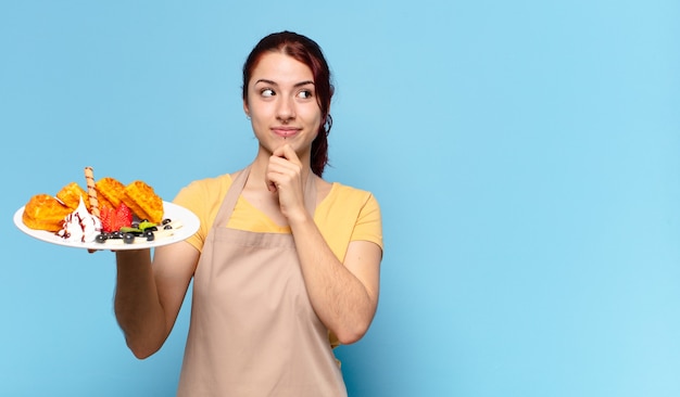 Femme employée de boulangerie Tty avec des gaufres et des gâteaux