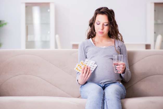 Femme enceinte assise sur un canapé