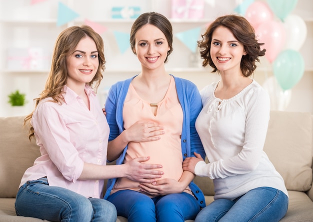 Femme enceinte avec ses amis souriant