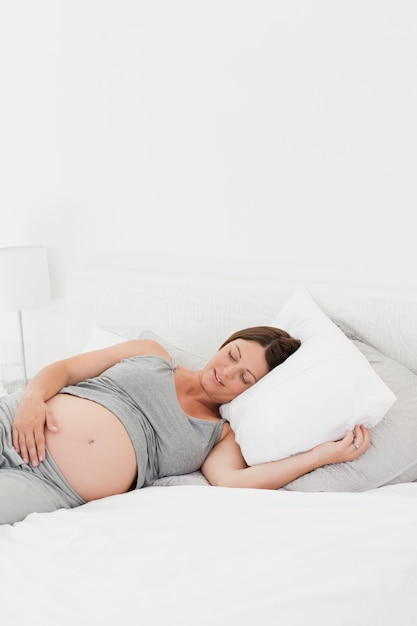 Femme enceinte sur son lit