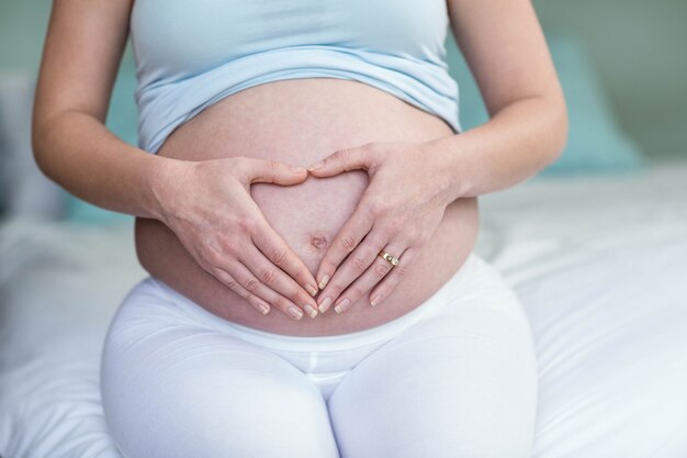 Femme enceinte toucher son ventre dans sa chambre