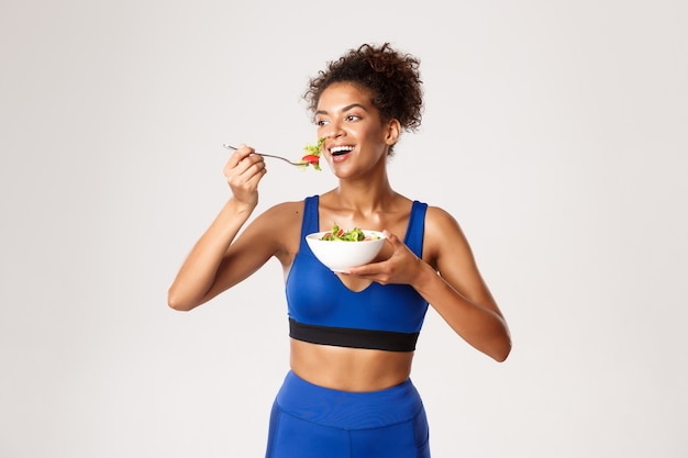 Femme expressive en vêtements de fitness posant