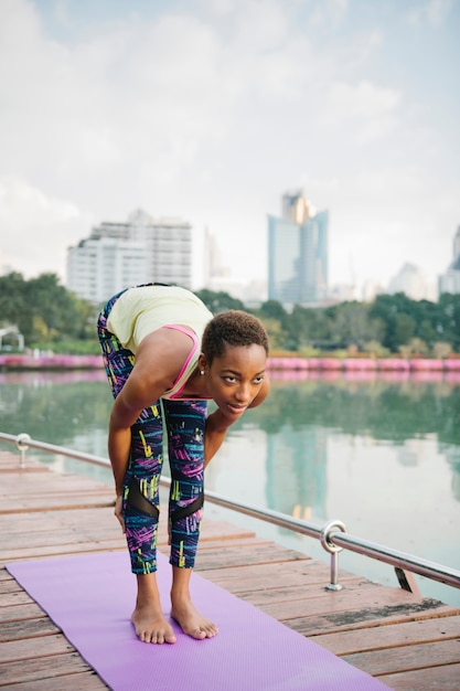Femme faisant du yoga au parc
