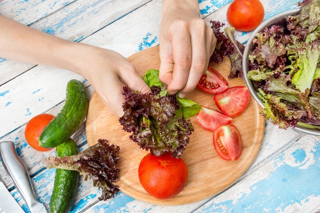 Femme faisant de la salade de légumes