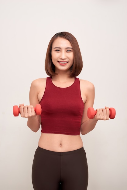 La femme fait de l'exercice avec des haltères