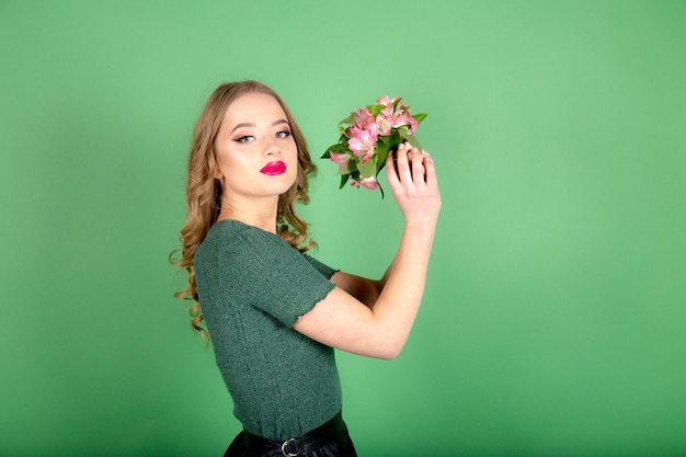 Femme avec des fleurs sur fond vert