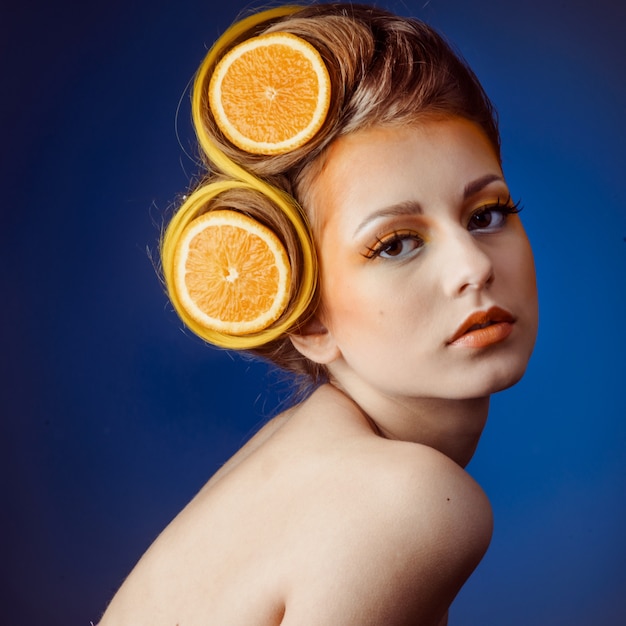 Femme avec fruit dans cheveux