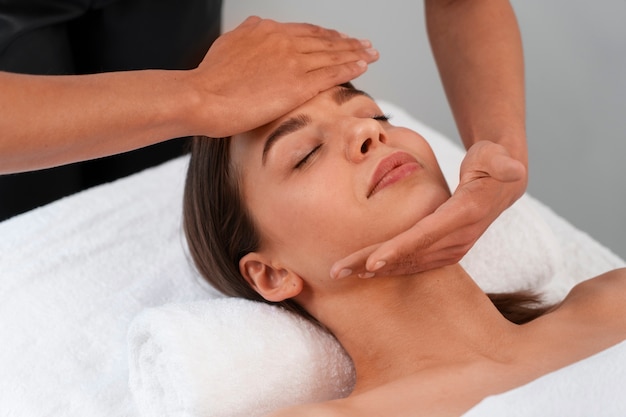 Femme grand angle pratiquant le yoga facial