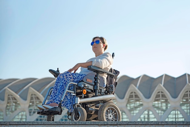 Une femme handicapée en fauteuil roulant dans la ville