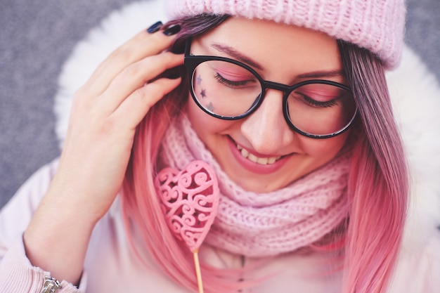 Femme heureuse aux cheveux roses inhabituels