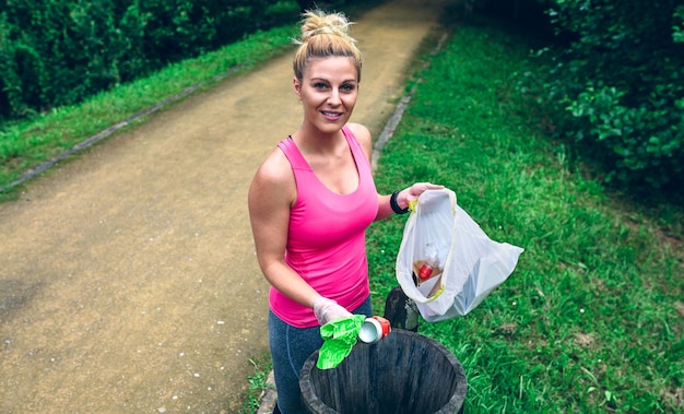 Photo femme jetant des ordures après plogging