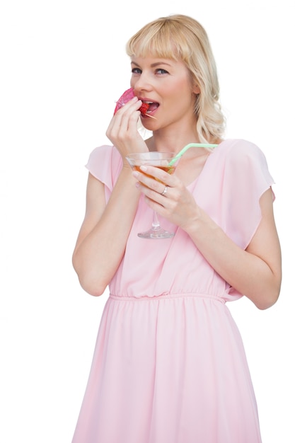 Femme jolie blonde avec cocktail, manger des fruits