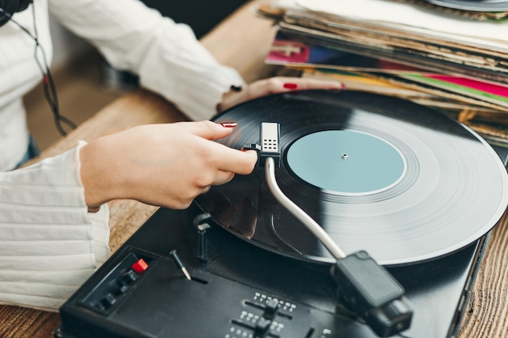 Photo femme jouant de la musique d'un disque vinyle disque analogique musique sonore analogique de style rétro et vintage
