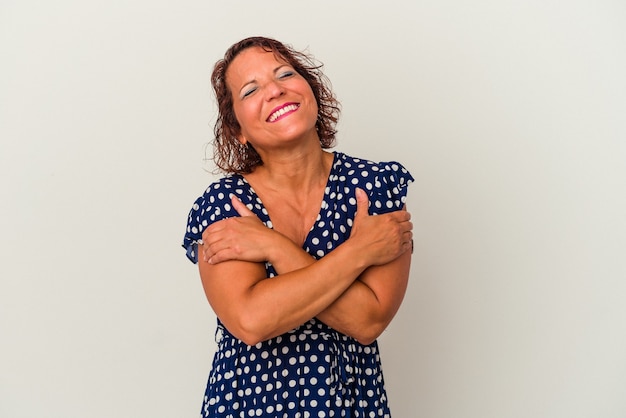 Femme latine d'âge moyen isolée sur fond blanc câlins, souriante insouciante et heureuse.