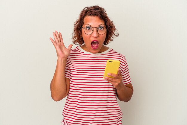 Femme latine d'âge moyen isolée sur fond blanc surprise et choquée.