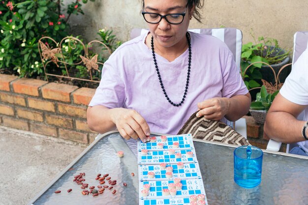 Femme avec des lunettes jouant à la loterie à la maison