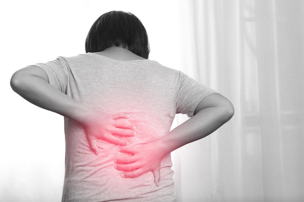 Photo une femme a mal au dos parce qu'elle est allongée dans la mauvaise position.