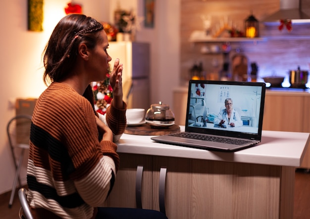 Femme malade appelant un médecin lors d'une vidéoconférence en ligne