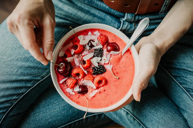 Femme mangeant un bol de smoothie sain