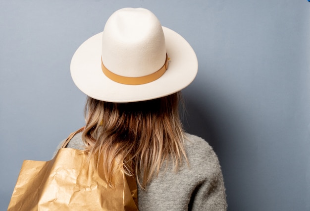 Femme en manteau avec sac à provisions