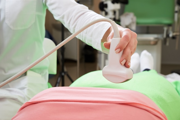 Femme médecin gynécologue opérant un scanner à ultrasons
