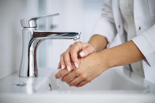 Femme médecin se laver les mains à l'hôpital