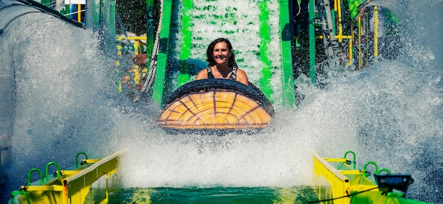 Femme sur des montagnes russes dans un parc à thème d'attractions