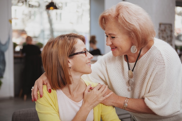 Femme mûre rencontre sa mère aînée au café