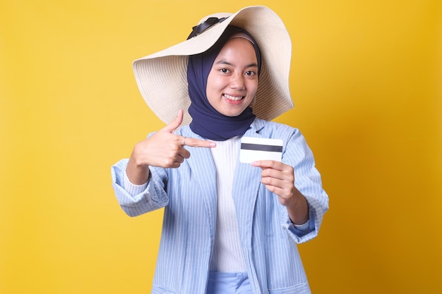 Femme musulmane asiatique pointant vers la méthode de paiement de la maquette de la carte de membre