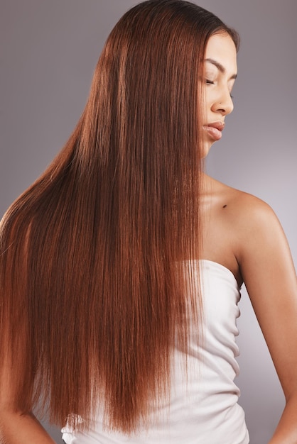 Femme noire aux cheveux bruns raides isolée sur fond de studio pour une brillance ou des soins de beauté saine