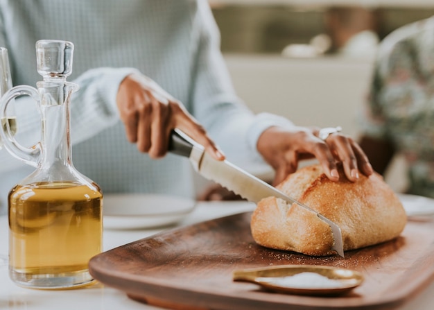 Femme noire coupant un pain au levain