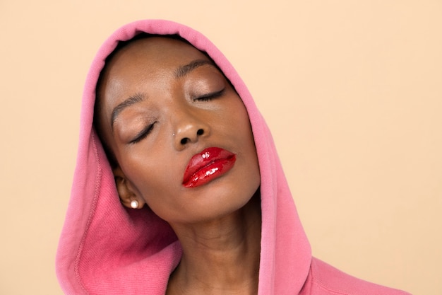 Femme noire dans un sweat à capuche rose