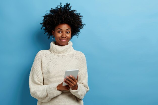 Photo une femme noire heureuse utilisant une tablette, naviguant sur internet et apprenant en ligne.