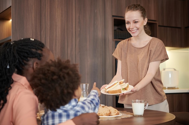 Femme offrant des sandwichs pour le petit déjeuner