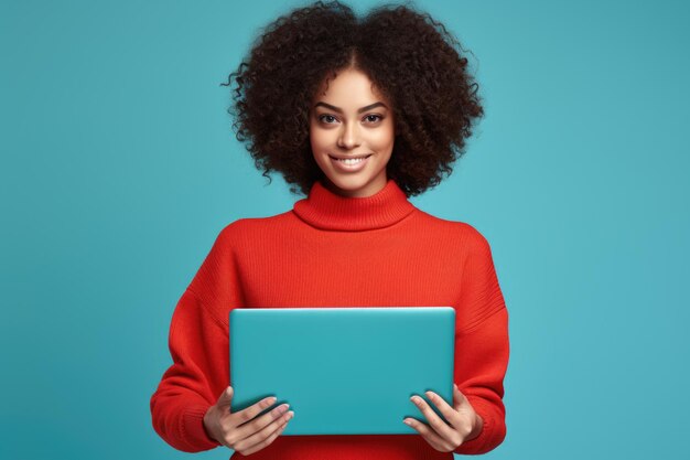 Photo une femme avec un ordinateur portable dans un pull rouge