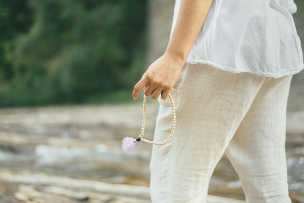 Une femme paisible fait de la méditation mantra près de la rivière