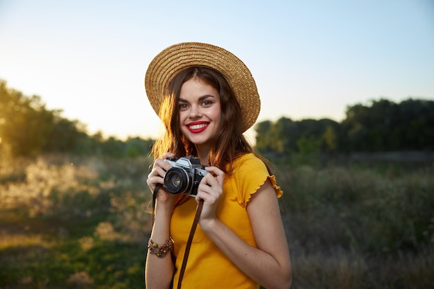 Femme photographe avec appareil photo dans les mains un instantané de l'air frais de la nature