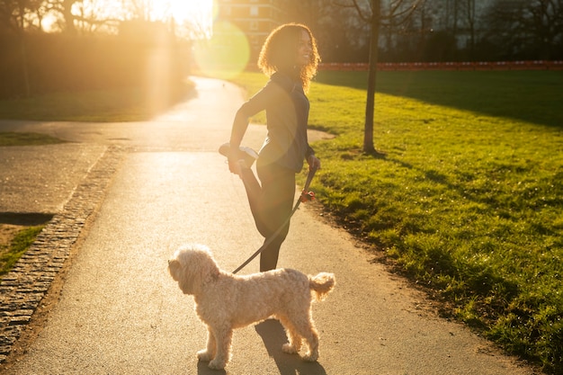 Photo femme plein coup avec un chien mignon à l'extérieur