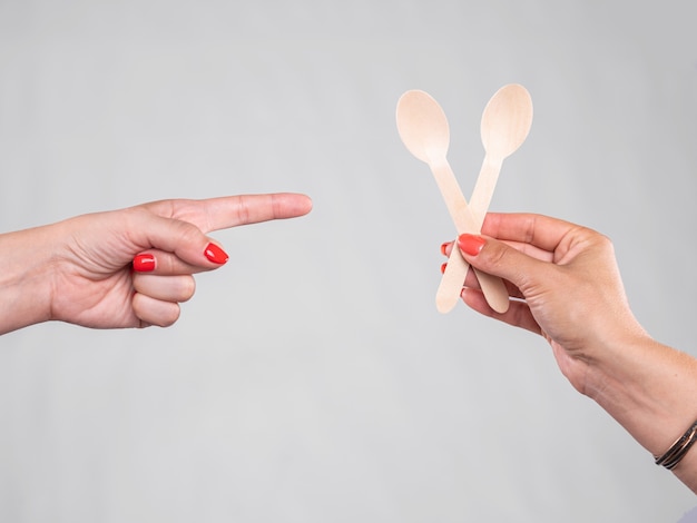 Femme pointant vers femme avec des cuillères en bois