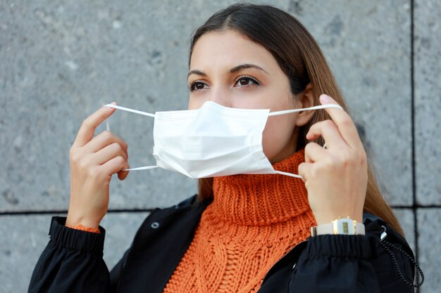 Femme portant un masque de protection dans la rue de la ville