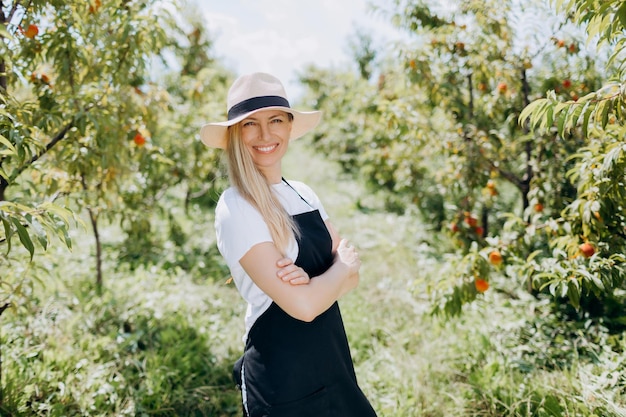 Femme posant sur une plantation de pêchers