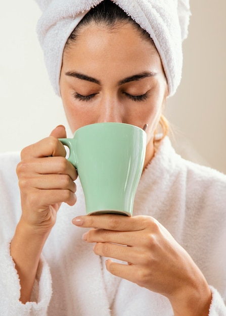 Femme prenant un café à la maison après le bain