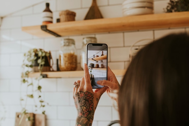 Femme prenant une photo de la décoration intérieure de la cuisine