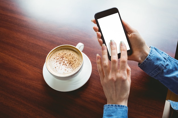 Femme prenant une photo de son café