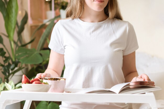 Femme prenant son petit déjeuner au lit