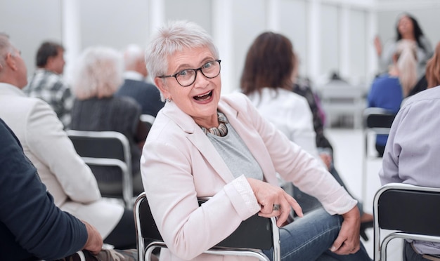 La femme à la présentation regarde la caméra