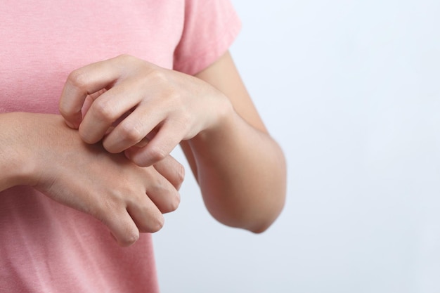 La femme de problèmes de santé a des démangeaisons des mains