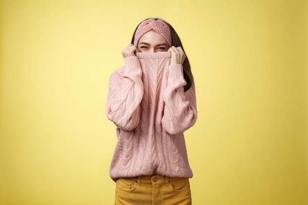 Femme avec pull rose sur jaune