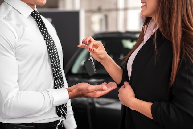 Femme qui passe des clés de voiture à un homme